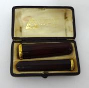 A cased pair of French amber and gold cigar/cigarette holders, Mathiss,