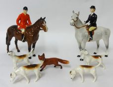 A Beswick huntsman, huntswoman, four dogs and a fox (8)
