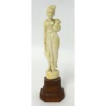 Small ivory carved figure of a Lady holding a water flask on wood base, 16cm.