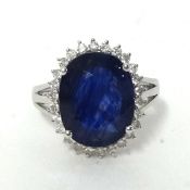 A 14k white gold and diamond set ring with oval cut blue sapphire approx 8ct, diamonds approximately