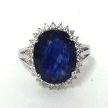 A 14k white gold and diamond set ring with oval cut blue sapphire approx 8ct, diamonds approximately