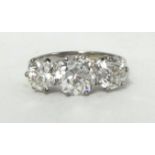 A fine three stone diamond Ring, claw set with old brilliant cut stones, the centre stone weighing