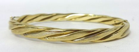 A 9ct gold twist design bangle, weight 18.3g.