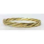 A 9ct gold twist design bangle, weight 18.3g.