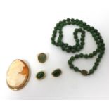 A jadeite bead Necklace, composed of 76 beads, a cabochon jade set Ring, a pair of Earclips, jade