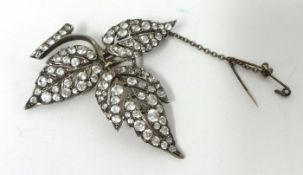 A silver set floral Brooch, set with white stones, of three leaf design, stamped 3CP, ENGLAND