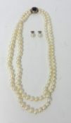 A two row cultured pearl Necklace, composed of 63 and 59 graduated beads, to an oval sapphire and