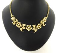 A Victorian gold and half pearl set Necklace, composed of floral sprays, multi link back chain,