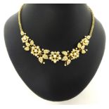 A Victorian gold and half pearl set Necklace, composed of floral sprays, multi link back chain,