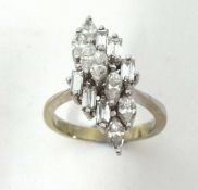A Ladies diamond cluster ring set with an arrangement of thirteen marquise and baguette cut diamonds