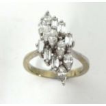 A Ladies diamond cluster ring set with an arrangement of thirteen marquise and baguette cut diamonds