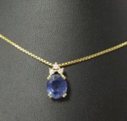 An 18ct gold sapphire and diamond Pendant, the claw set mixed cut stone with three small brilliant