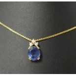 An 18ct gold sapphire and diamond Pendant, the claw set mixed cut stone with three small brilliant