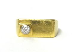 An 18ct gold signet ring, set with single diamond, approx 10.90g.