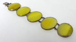 A modern stylish white metal bracelet set with five oval yellow agate stones, 20cm long