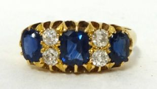 A seven stone sapphire and diamond ring, set in 18ct gold.