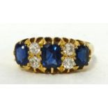 A seven stone sapphire and diamond ring, set in 18ct gold.