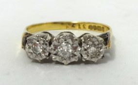 An 18ct gold diamond three stone ring, size N