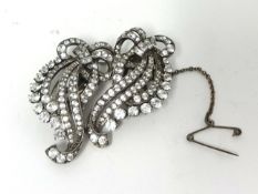 A silver set double clip Brooch, claw set with white stones, of scroll design, stamped 3CP,