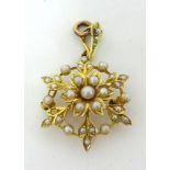 A Victorian gold and half pearl set floral Brooch/Pendant, of openwork design, the bail stamped