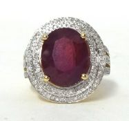 A 14k yellow gold diamond ring set with an oval cut ruby approx 10ct, diamonds approx 1.10total