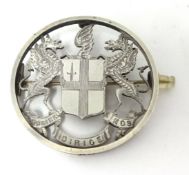 A silver brooch with crest depicting the Latin motto of the City of London 'Domine dirige no's',