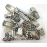 A mixed bag of silver and other white metal objects including thimbles, spoons, sewing hooks, etc