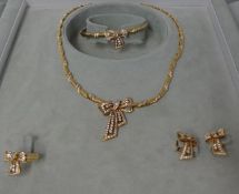 A gold and diamond set suite of jewellery, comprising a Necklace, a Bangle, a Ring and a pair of