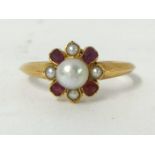A ruby and pearl cluster Ring, the central bead, untested, bordered by 1/2 pearls and mixed cut