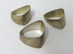 Three heavy bark finish triangular napkin rings by House of Lawrian, for Christopher N Lawrence,