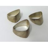 Three heavy bark finish triangular napkin rings by House of Lawrian, for Christopher N Lawrence,