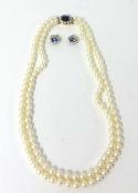 Two row pearl necklace with 18ct clasp set with sapphire and diamonds and a pair of earrings