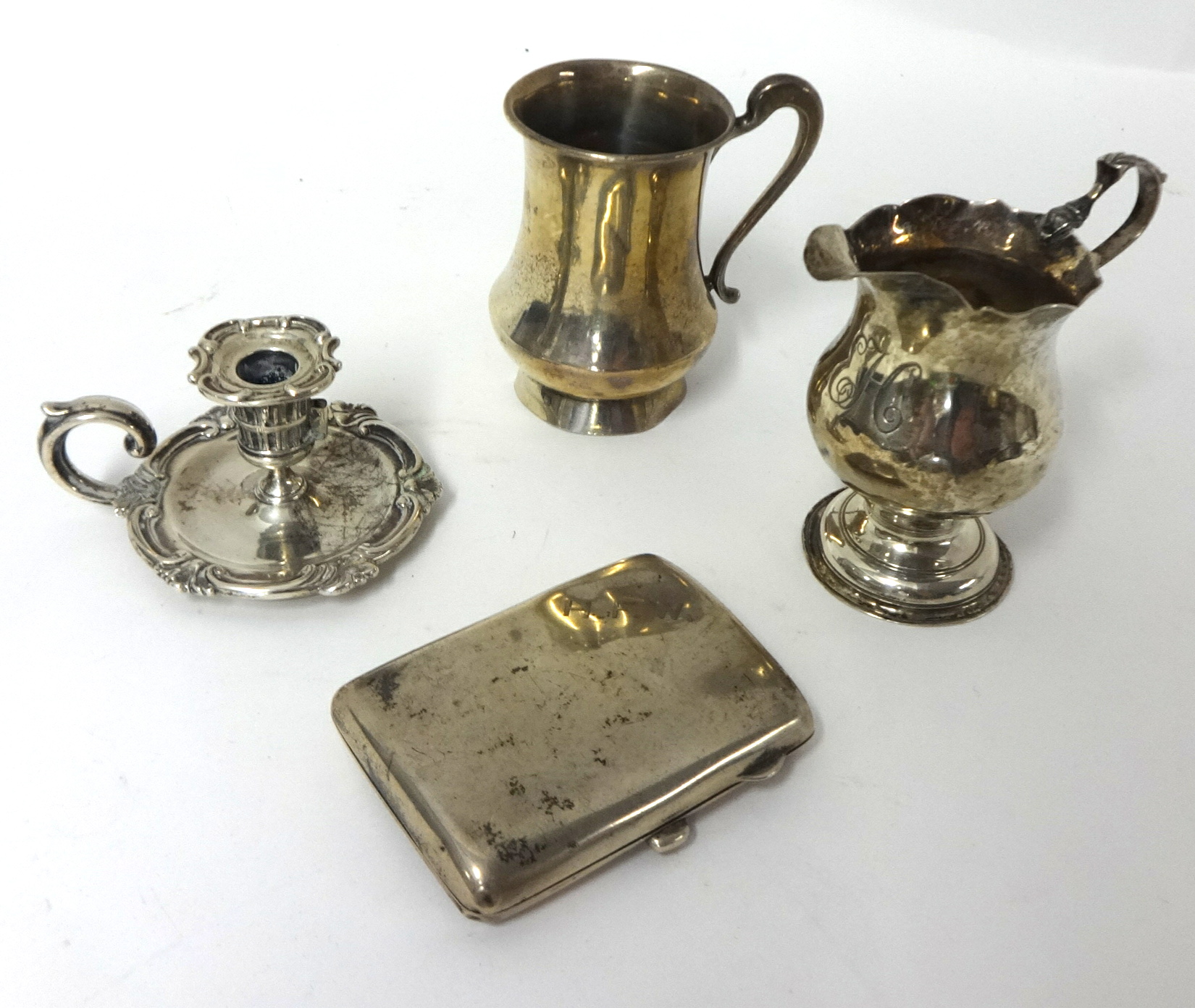 A Victorian silver small chamberstick, by J. & J. Angel, London 1841, a George III silver cream jug,