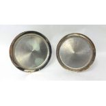 A pair of matching silver salvers with plain polished borders and bark finished centres by House