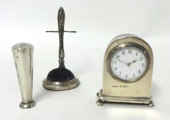 A miniature silver time piece, a Victorian silver ring stand and a silver seal (3)