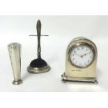 A miniature silver time piece, a Victorian silver ring stand and a silver seal (3)