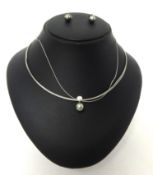 An 18ct white gold single stone diamond and Tahitian black pearl Necklace, the collet set stone