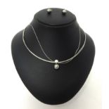 An 18ct white gold single stone diamond and Tahitian black pearl Necklace, the collet set stone