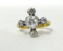 A diamond cluster Ring, claw set with an old cut stone weighing approximately 1.6cts, colour
