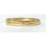 Georg Jensen. An 18ct three colour gold Fusion Bangle, London 2011, size medium, weight 37 grams.