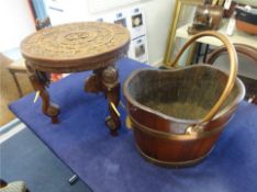 An old wood and copper bound bucket t/w an Indian occasional carved hardwood table with elephant