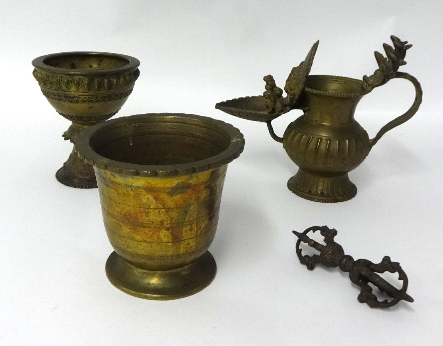 An antique brass Indonesian mortar, a goblet and two other items (4).
