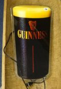 An illuminated Guinness advertising sign.