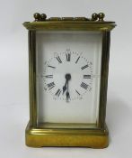 A French brass cased carriage clock with platform escapement and Roman and arabic numerals with key,