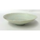 A small Chinese celadon glazed porcelain dish, with faint underglaze decoration, probably Song