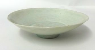 A small Chinese celadon glazed porcelain dish, with faint underglaze decoration, probably Song