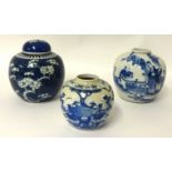 A Chinese blue and white ginger jar and another smaller decorated with trees and plants (2), tallest