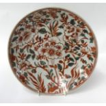 An antique Chinese shallow dish decorated in red and green, with stylised flowers, diameter 35cm.