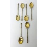 A set of six silver and gold golfing spoons made in The Kolar Goldfields India with box.