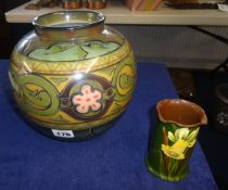 A German pottery vase and a Torquay daffodil patterned pot, 21cm.